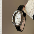A lady with an oval-shaped small gold watch