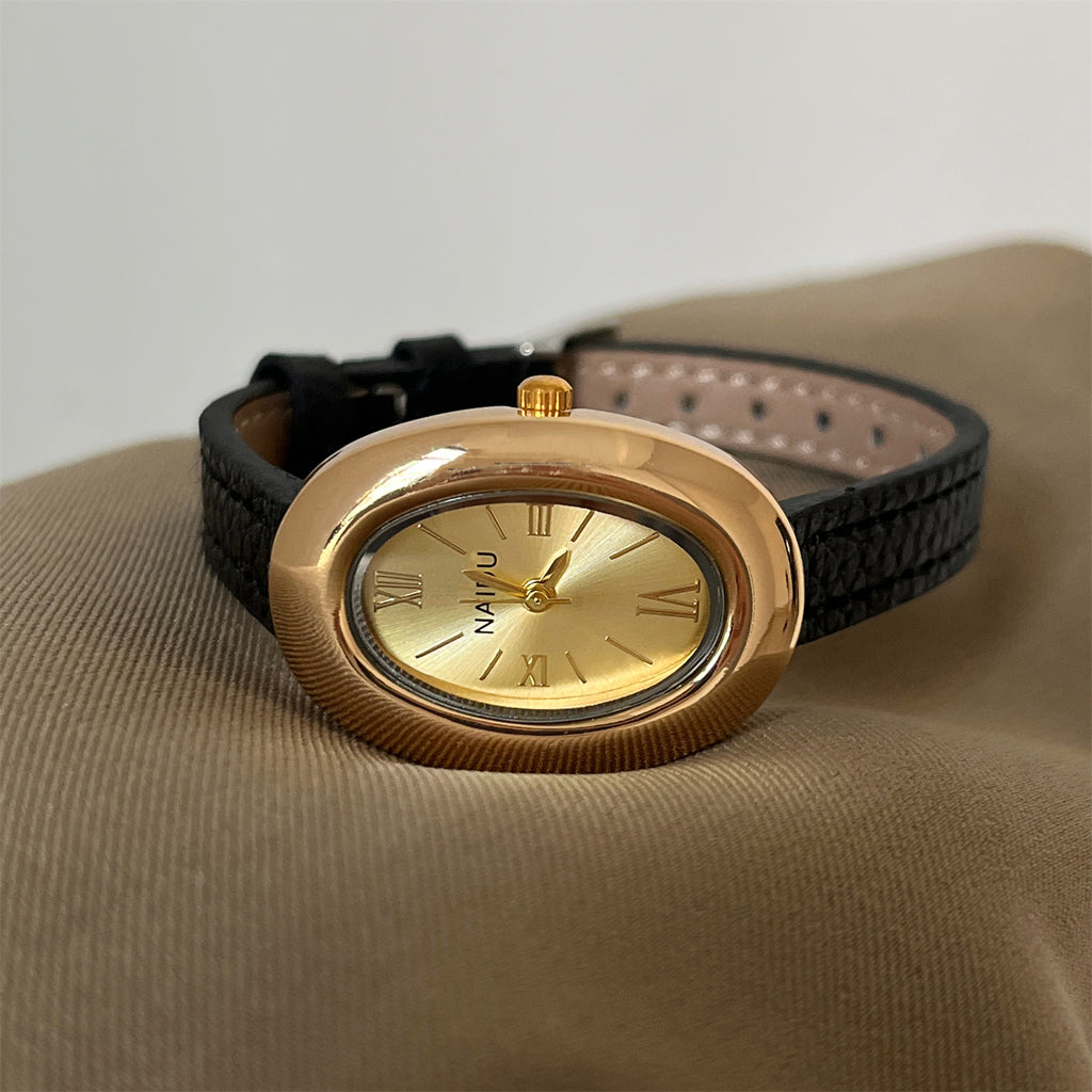 A lady with an oval-shaped small gold watch