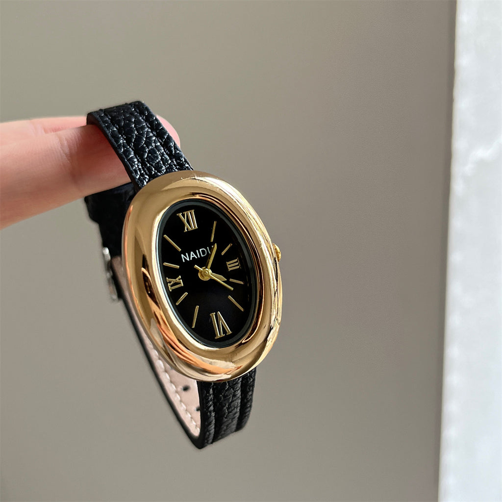 A lady with an oval-shaped small gold watch