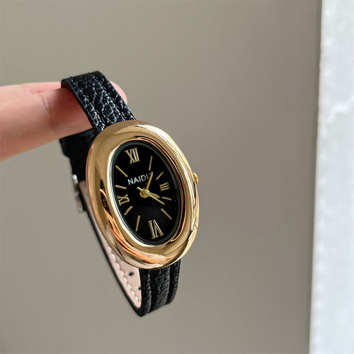 A lady with an oval-shaped small gold watch